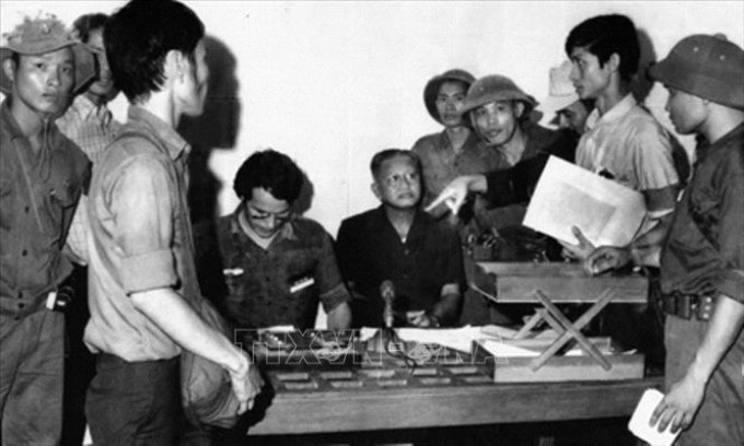 Trong ảnh: Tổng thống Ngụy Dương Văn Minh cùng nội các ra trước Đài Phát thanh Sài Gòn tuyên bố đầu hàng vô điều kiện, kết thúc chiến tranh Việt Nam, trưa 30/4/1975. Ảnh: Tư liệu/TTXVN phát